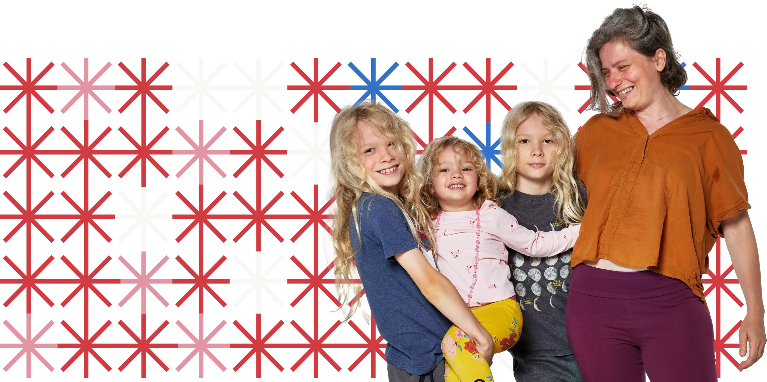 A parent and three children, all with light skin and light hair, stand with their arms around each other.