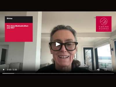 A screenshot of an older woman with glasses smiling indoors, recording her Medicaid story.